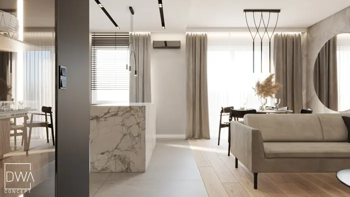 Otwarta strefa dzienna z marmurową wyspą kuchenną, jadalnią i sofą - apartament w Krakowie
