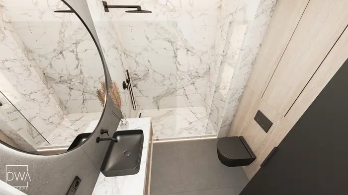 Detal umywalki i czarnej toalety w łazience z marmurową ścianą - apartament w Krakowie