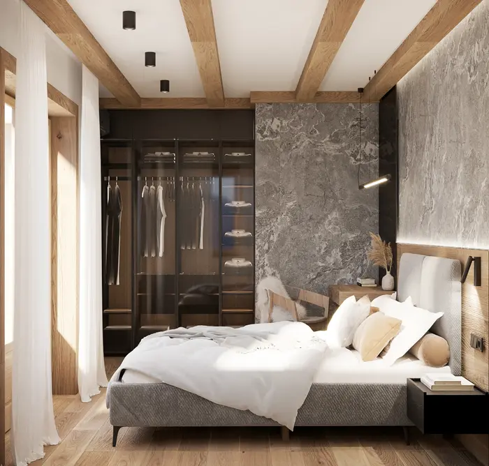 Sypialnia z czarną szafą za szklanymi drzwiami i kamienną ścianą przy łóżku - apartament w Kościelisku
