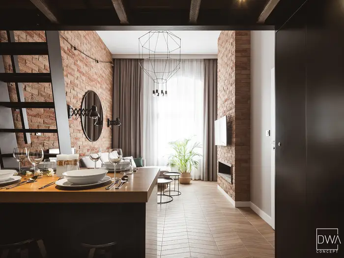 Nakryty stół barowy z kieliszkami przy ceglanej ścianie - apartament w Krakowie 22m2