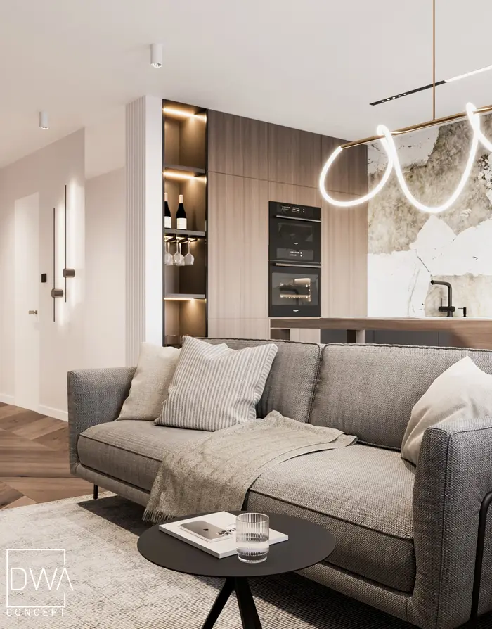Salon z szarą sofą, podświetlaną półką na wino i kuchnią w tle - apartament w Rabce-Zdroju